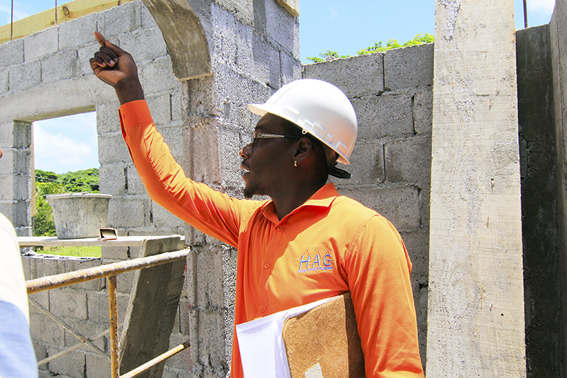HAG professional inspecting blockwork in an archive photograph